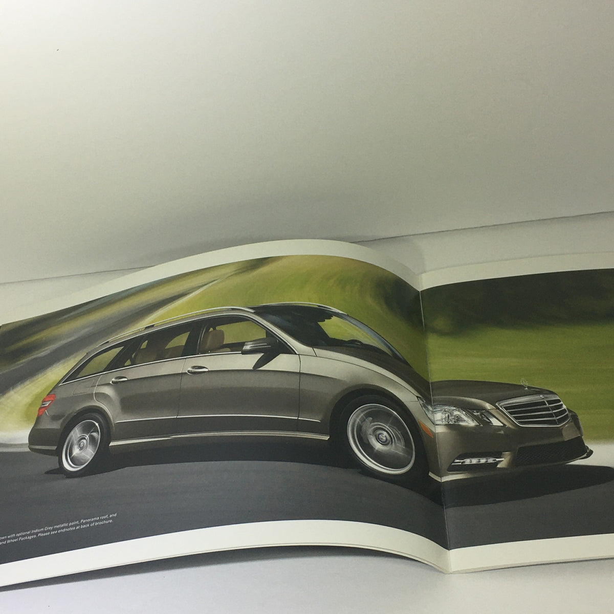 2013 Mercedes-Benz E-Class Sedan and Wagon Dealership Car Auto Brochure Catalog image featuring a sleek tan wagon driving on a winding road.