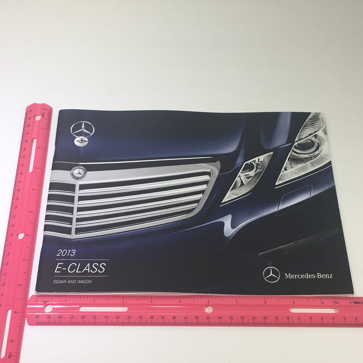 2013 Mercedes-Benz E-Class Sedan and Wagon Dealership Car Auto Brochure Catalog cover featuring the striking grille design and logo, emphasizing the luxury of the vehicle.