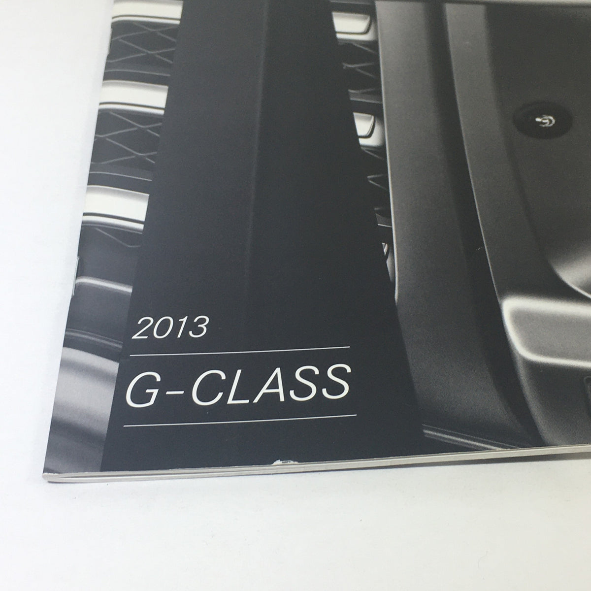 2013 Mercedes-Benz G-Class 4x4 AMG Dealership Car Auto Brochure Cover, featuring sleek design and the model name G-CLASS prominently displayed.
