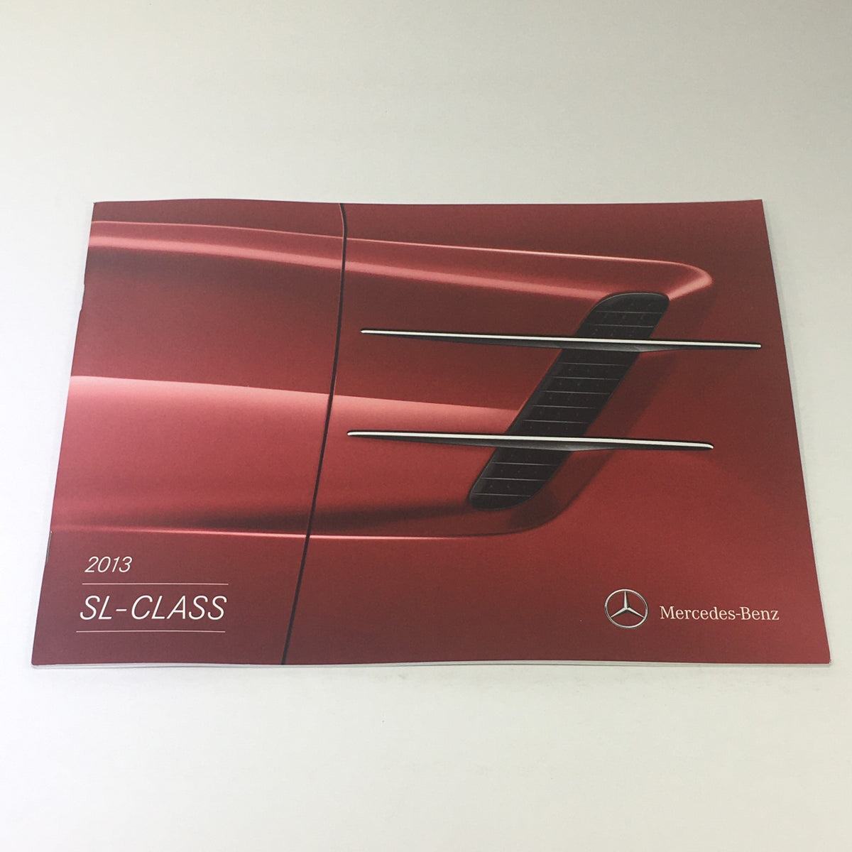 Cover of the 2013 Mercedes-Benz SL-Class Dealership Car Auto Brochure Catalog, showcasing the sleek design and distinctive grille elements.