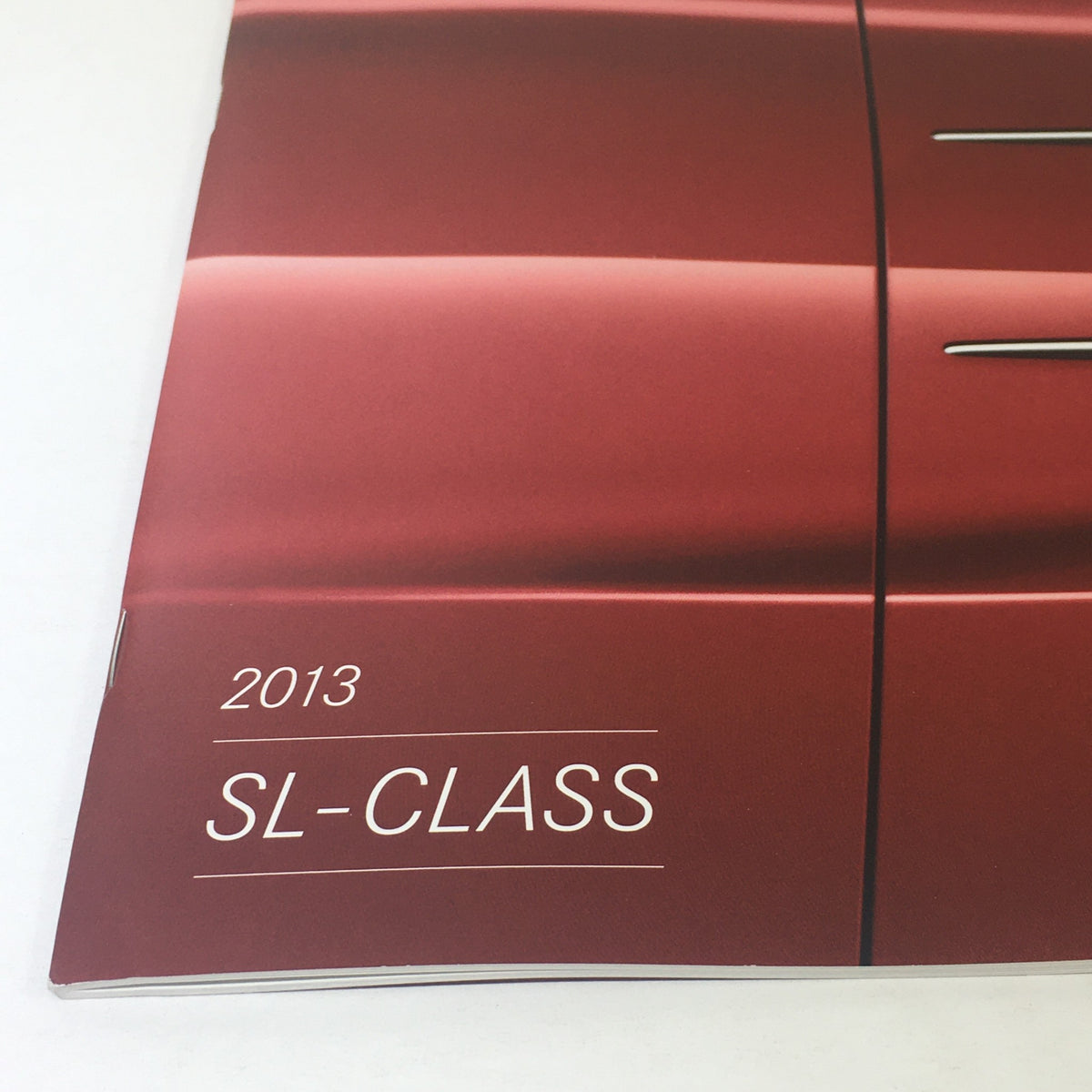 Close-up view of the 2013 Mercedes-Benz SL-Class title on the catalog cover, highlighting the elegant branding and luxurious design.