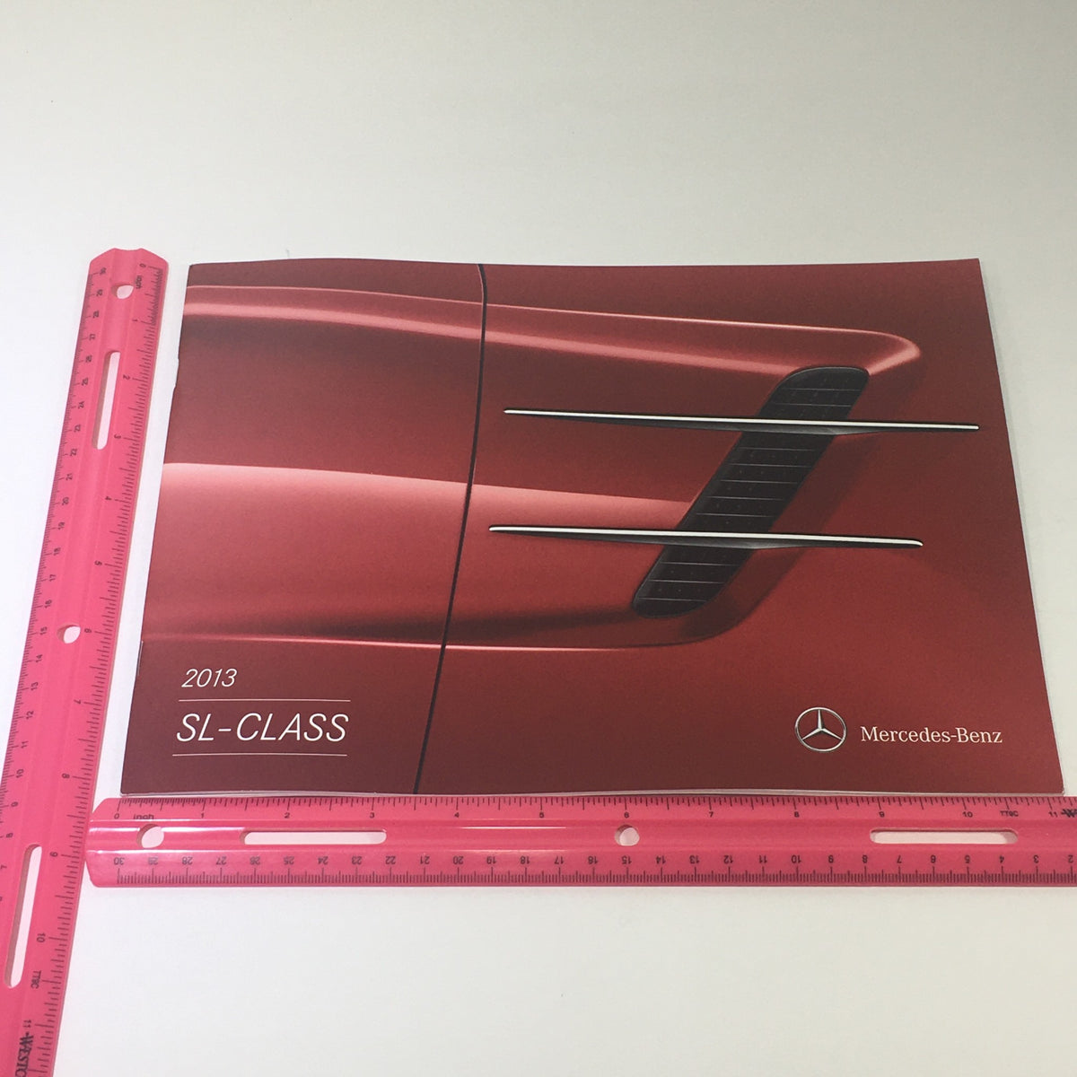 Front cover of the 2013 Mercedes-Benz SL-Class Dealership Car Auto Brochure Catalog displaying a striking image of the SL-Class design elements.