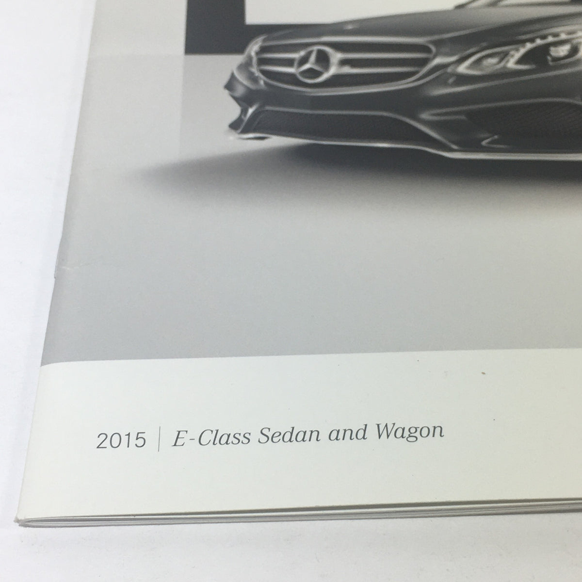Close-up of the 2015 Mercedes-Benz E-Class Sedans & Wagon Dealership Car Auto Brochure Catalog showing the title and design elements.