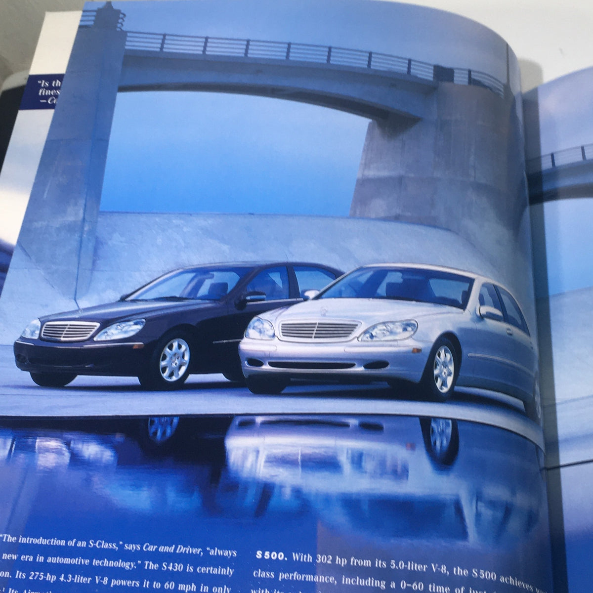 Page from the 2001 Mercedes-Benz S-Class catalog featuring two models, one black and one silver, showcasing their elegant design and performance specifications.