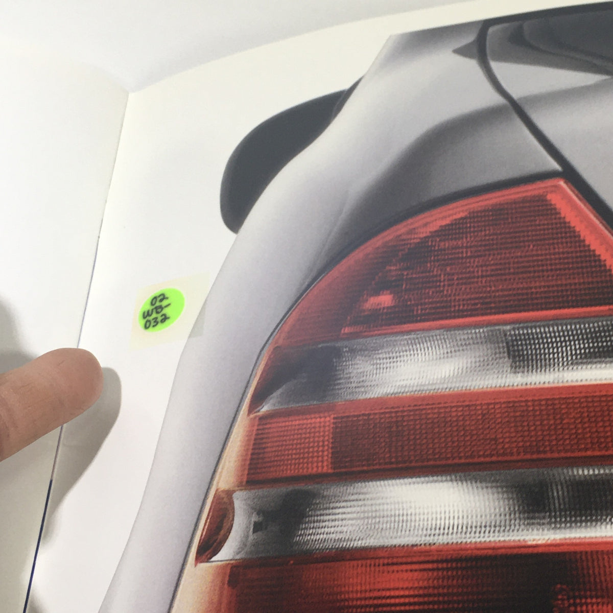 Detail of the rear taillight from the 2001 Mercedes-Benz E-Class Dealership Car Auto Brochure Catalog, marked with a sticker label.