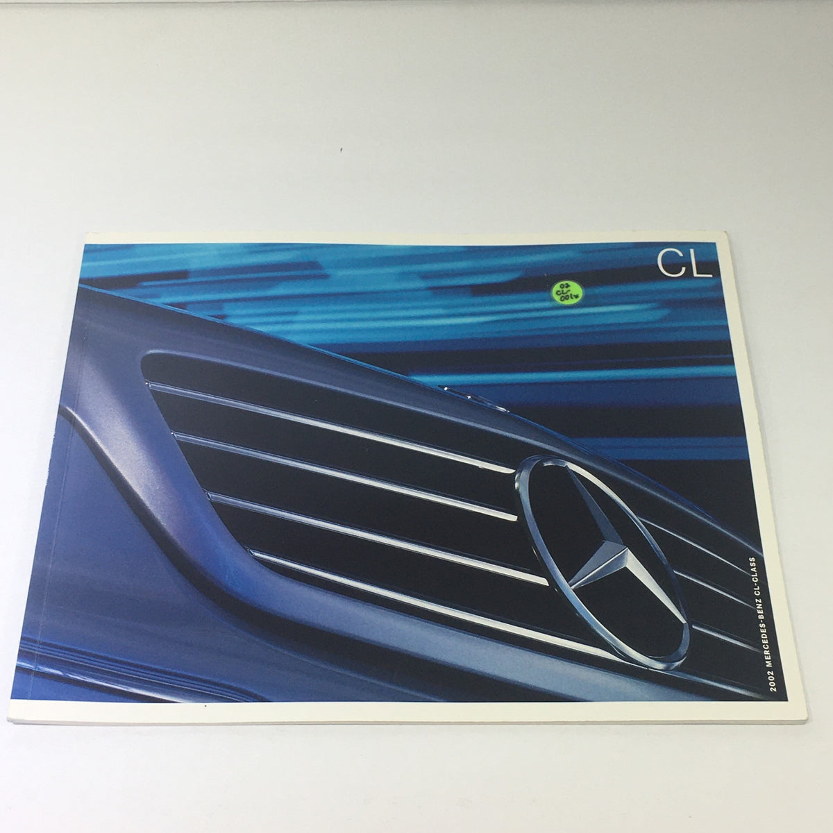 Cover of the 2002 Mercedes-Benz CL-Class Dealership Car Auto Brochure Catalog featuring the iconic Mercedes-Benz grille and logo, showcasing the luxury design and elegance associated with the brand.
