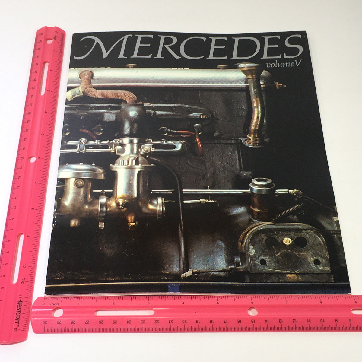 Cover image of the 1982 Mercedes-Benz Volume V Dealership Car Auto Brochure Catalog, illustrating engine components and design intricacies, emphasizing luxury automotive heritage.