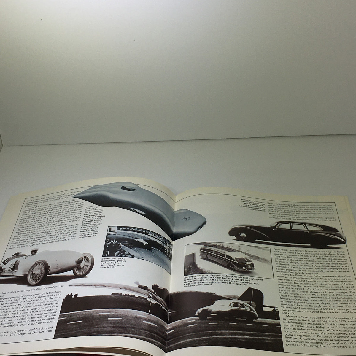 Interior pages of the 1982 Mercedes-Benz Volume VI Dealership Car Auto Brochure Catalog featuring images of vintage cars and detailed descriptions highlighting their design.