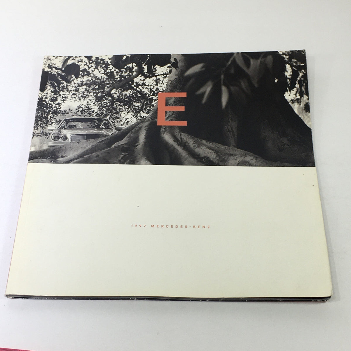 Cover of the 1997 Mercedes-Benz E Class Coupe Dealership Car Auto Brochure Catalog, featuring a minimalist design with a tree close-up and the letter 'E'.