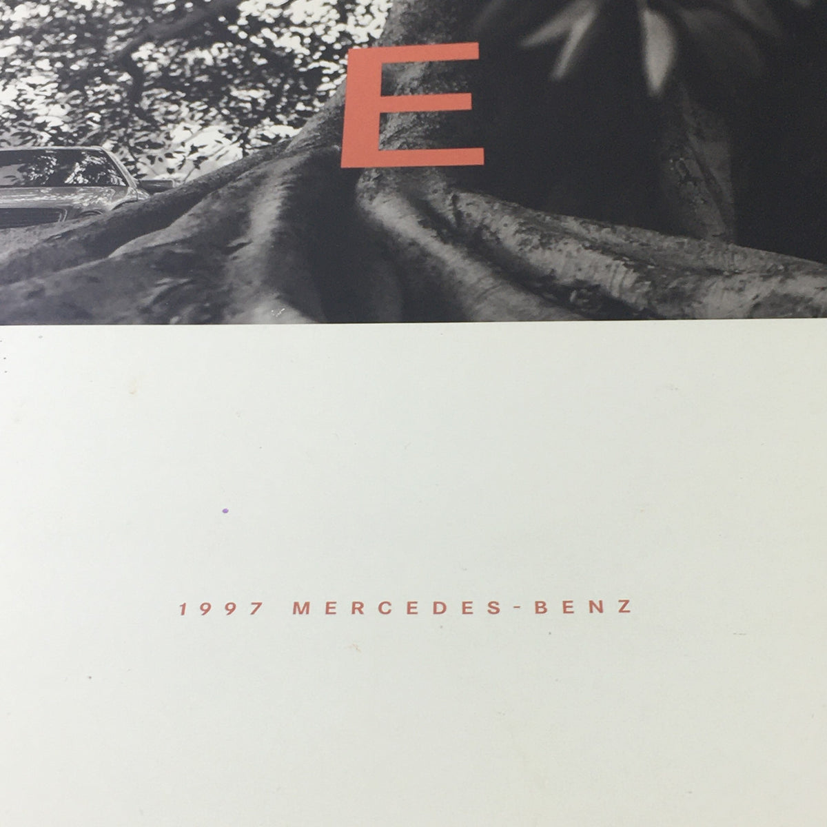 Close-up view of the cover of the 1997 Mercedes-Benz E Class Coupe Dealership Car Auto Brochure Catalog, highlighting the text '1997 MERCEDES-BENZ'.