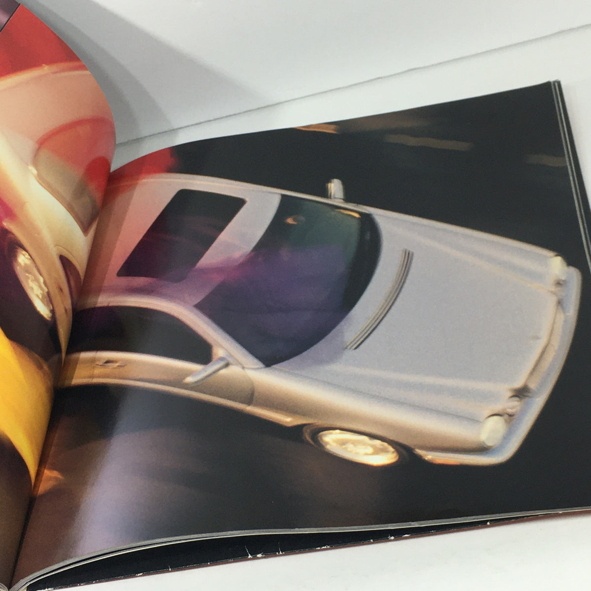 Overhead perspective of a silver 1997 Mercedes-Benz E Class Coupe from the dealership car auto brochure catalog, illustrating its stylish silhouette and modern aesthetics.
