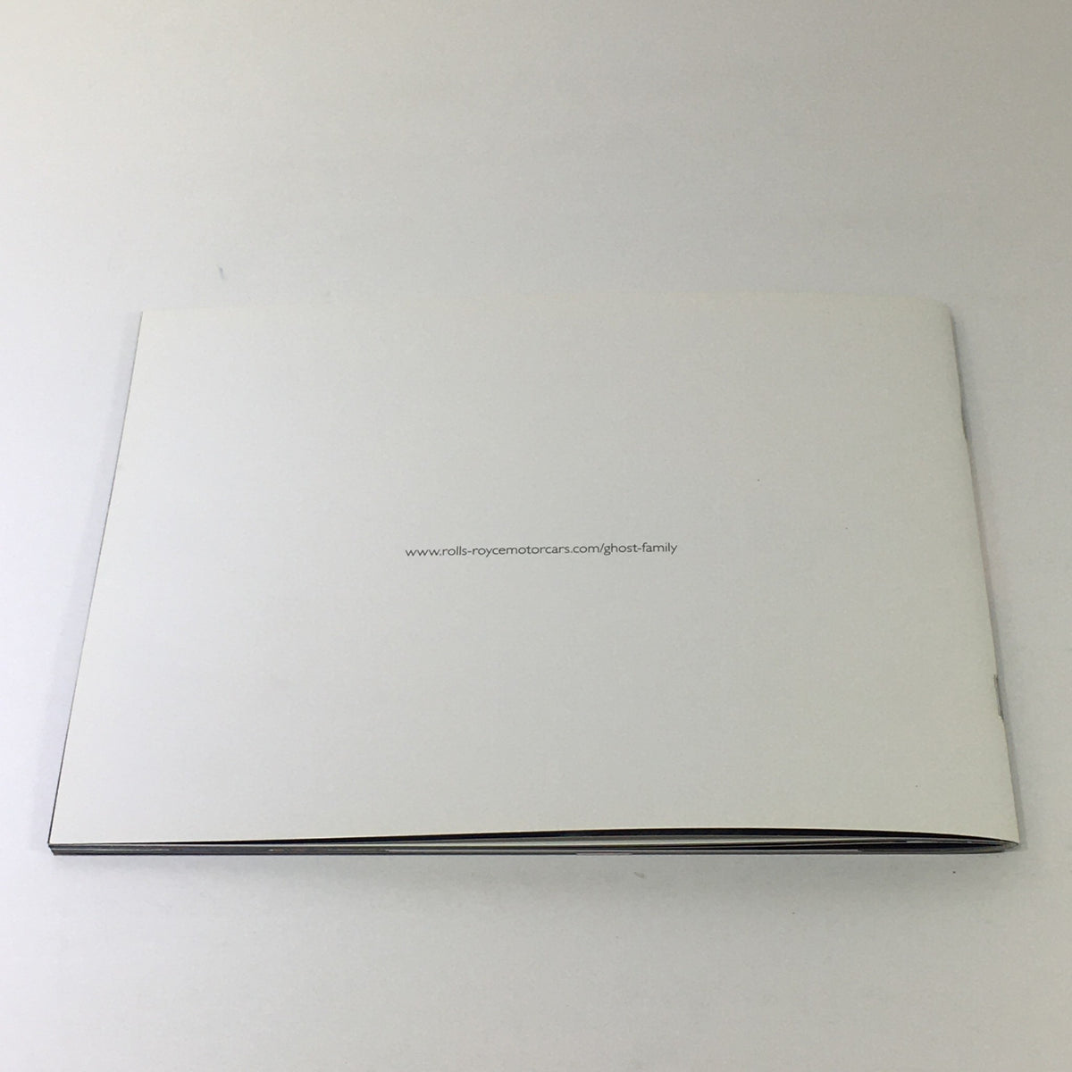 Back cover of the 2014 Rolls Royce Ghost Family Dealership Car Auto Brochure Catalog, featuring a minimalist design and website link for more information.