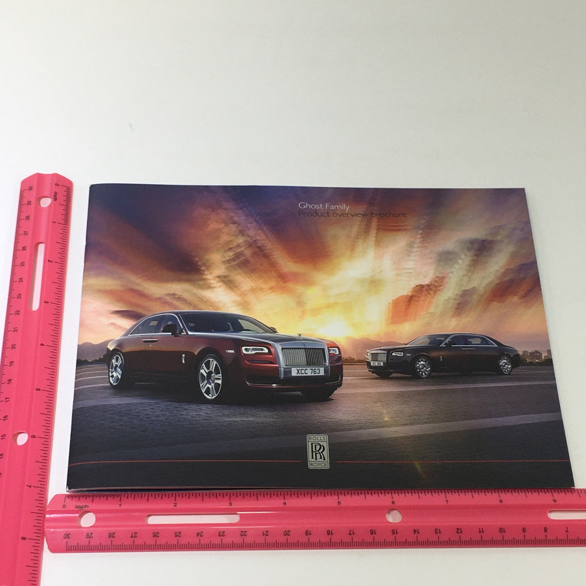 Front cover of the 2014 Rolls Royce Ghost Family Dealership Car Auto Brochure Catalog, displaying two Rolls Royce Ghost models beneath a dramatic sky.