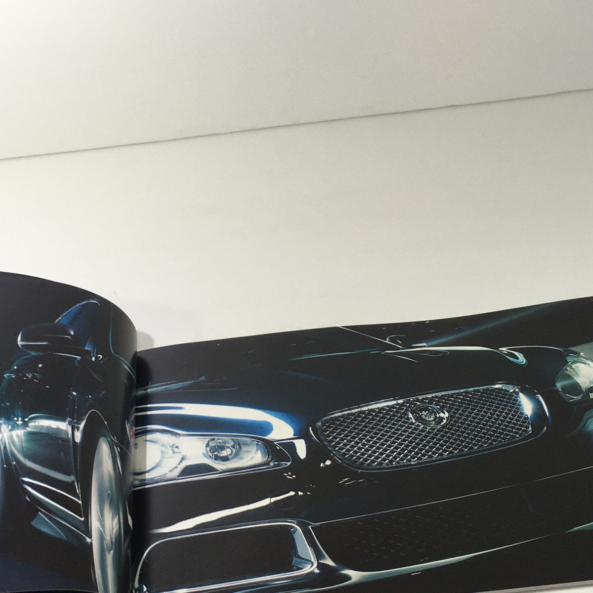 2010 Jaguar The XF Collection Dealership Car Auto Brochure Catalog featuring the front grille of a Jaguar XF, showcasing its stylish and sophisticated design.