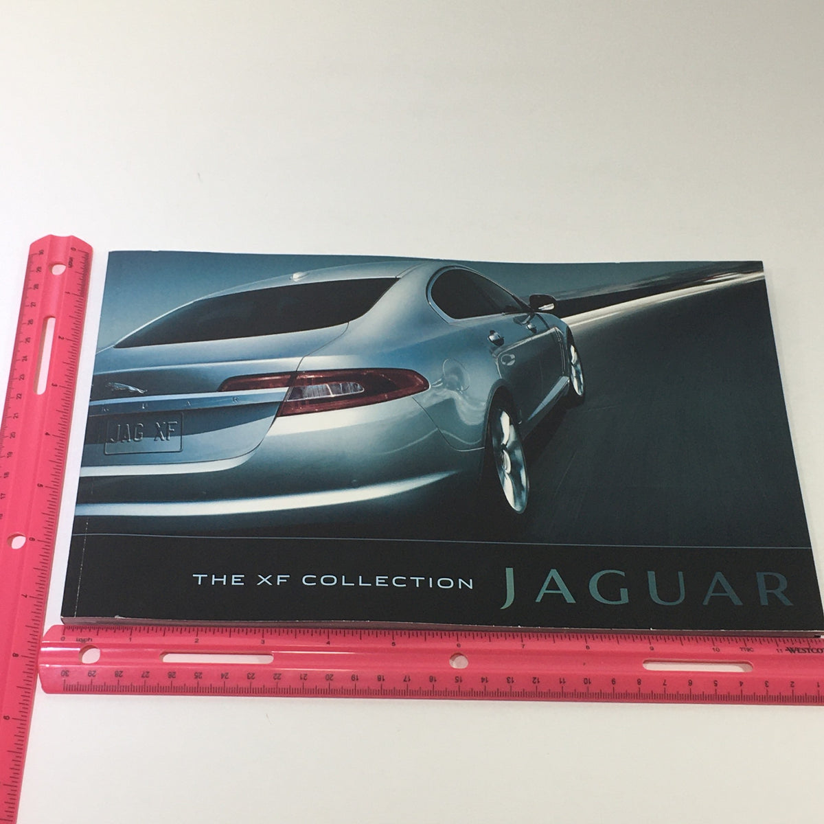 2010 Jaguar The XF Collection Dealership Car Auto Brochure Catalog showcasing a stylish silver Jaguar XF car on a modern road.