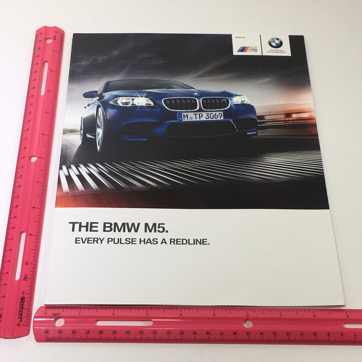 2014 BMW M5 Dealership Car Auto Brochure Catalog front cover, showcasing the BMW M5 with the tagline 'Every Pulse Has a Redline' and featuring dynamic racing imagery.