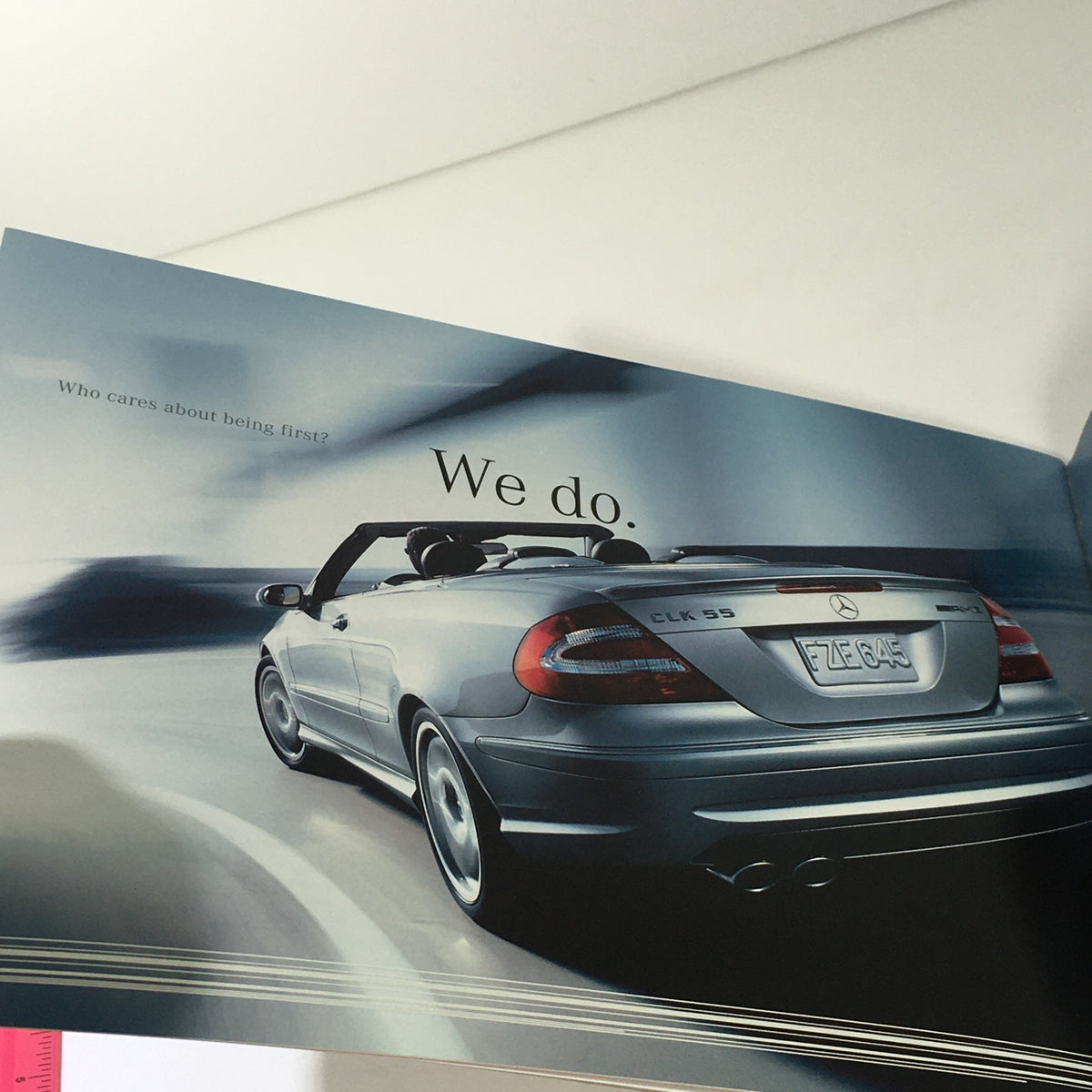 2005 Mercedes-Benz CLK-Class Dealership Car Auto Brochure Catalog showcasing a sleek convertible car on the road with the tagline 'We do.'