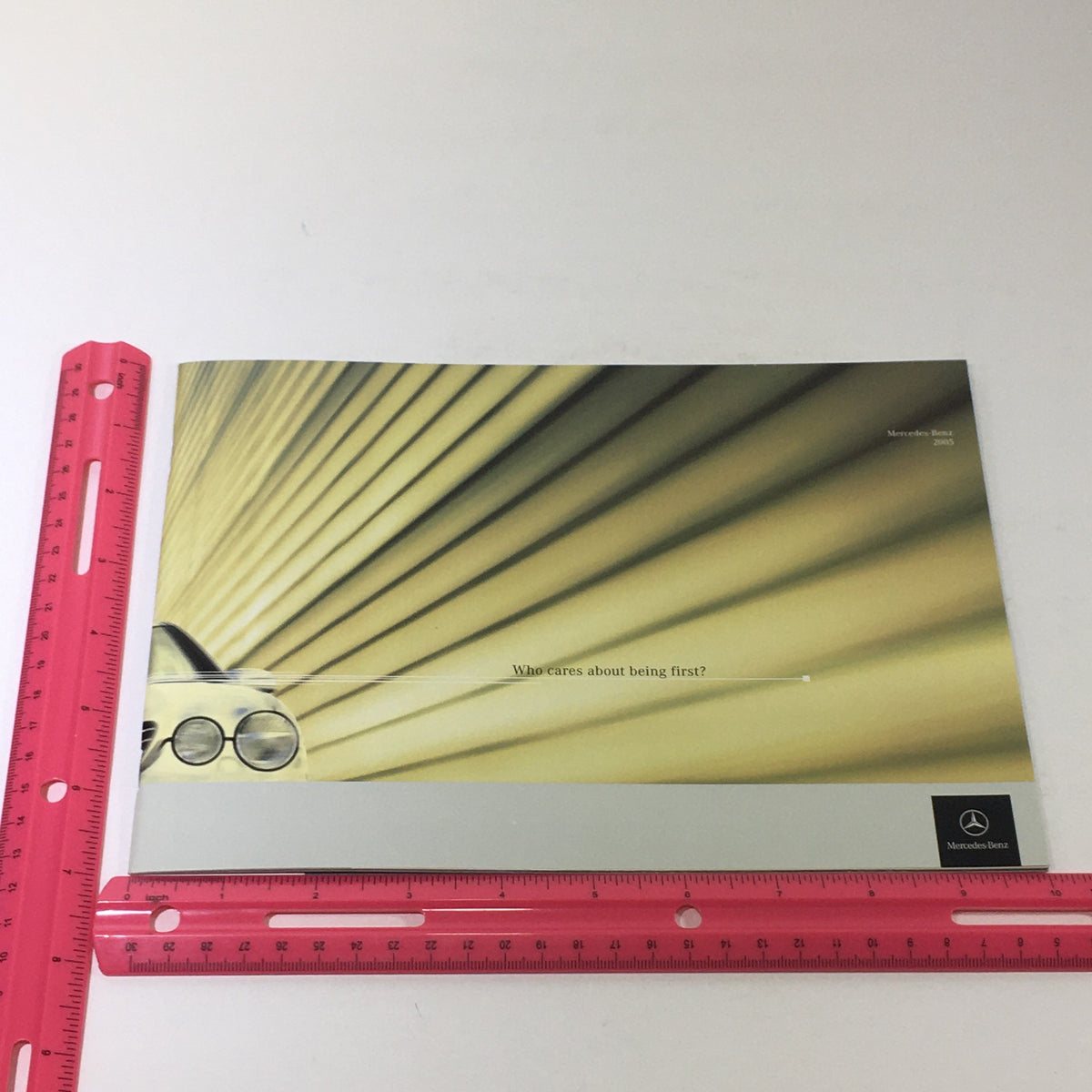 2005 Mercedes-Benz CLK-Class Dealership Car Auto Brochure Catalog displaying an artistic layout with the phrase 'Who cares about being first?' emphasized.