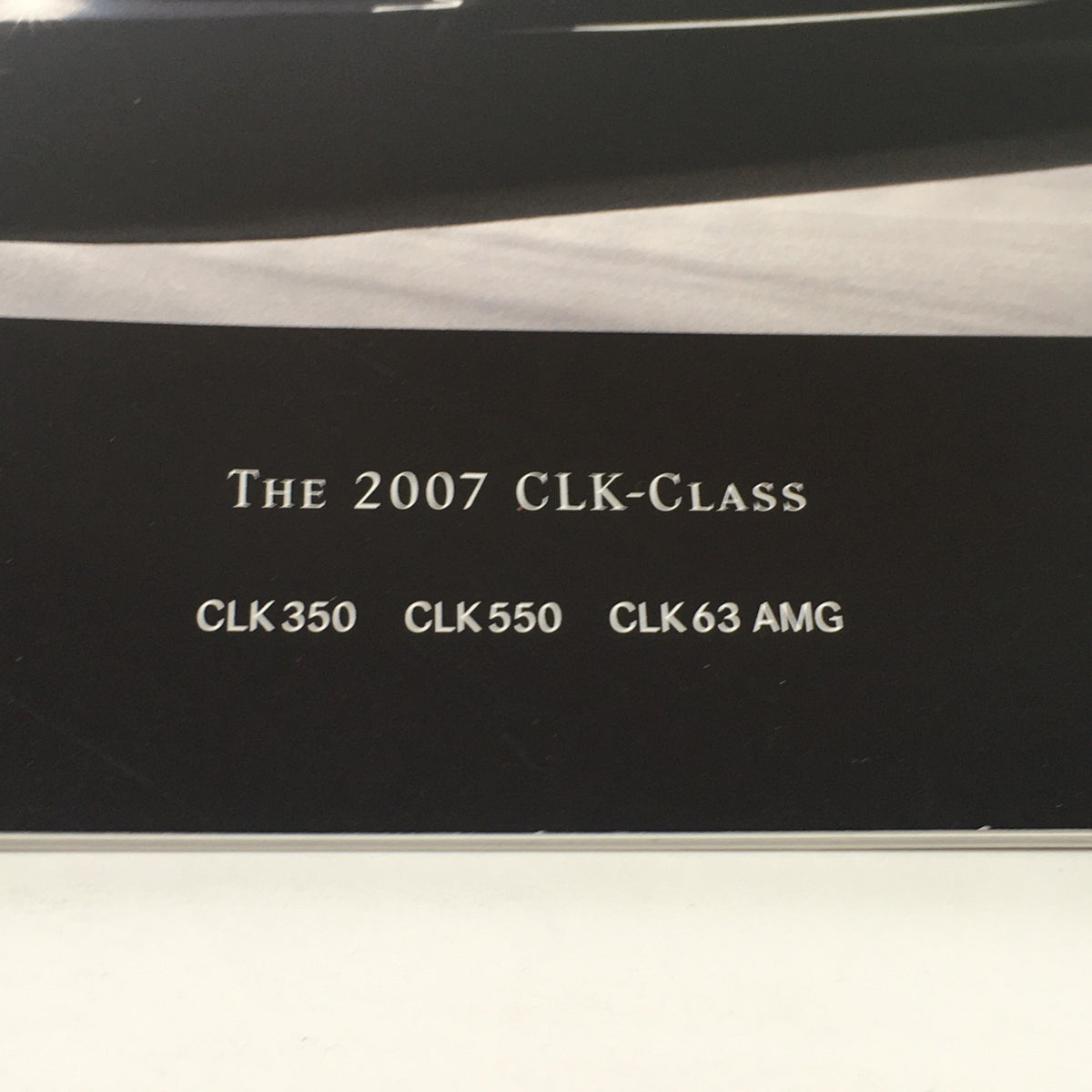 Detailed image of the 2007 Mercedes-Benz CLK-Class specifications featuring CLK 350, CLK 550, and CLK 63 AMG, taken from the dealership auto brochure.