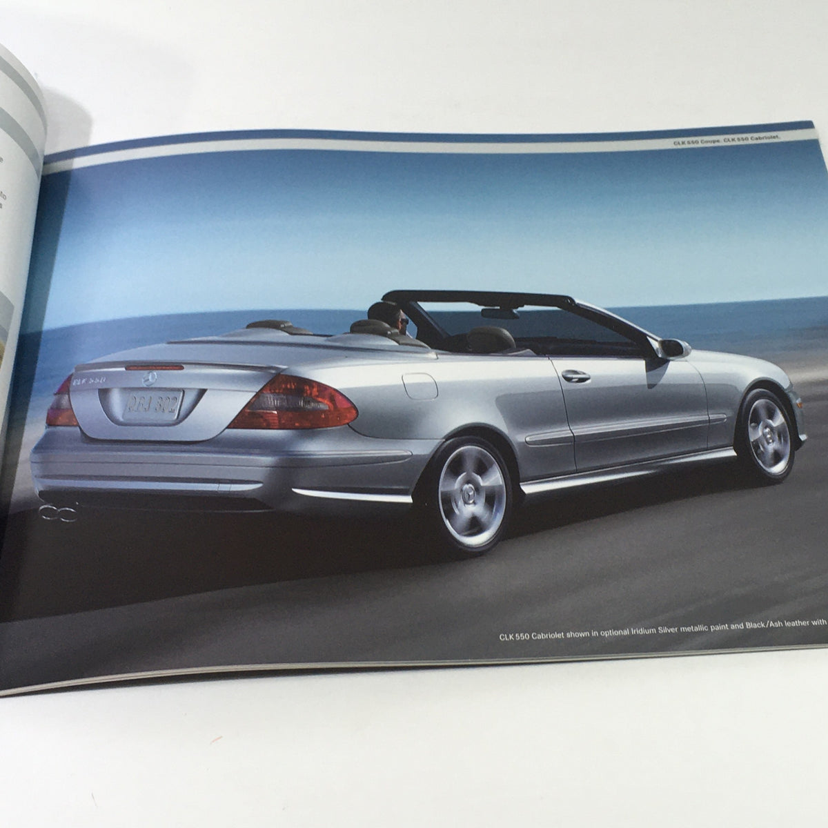 Image of a 2007 Mercedes-Benz CLK 550 Cabriolet from the dealership auto brochure, showcasing the car's sleek rear design.