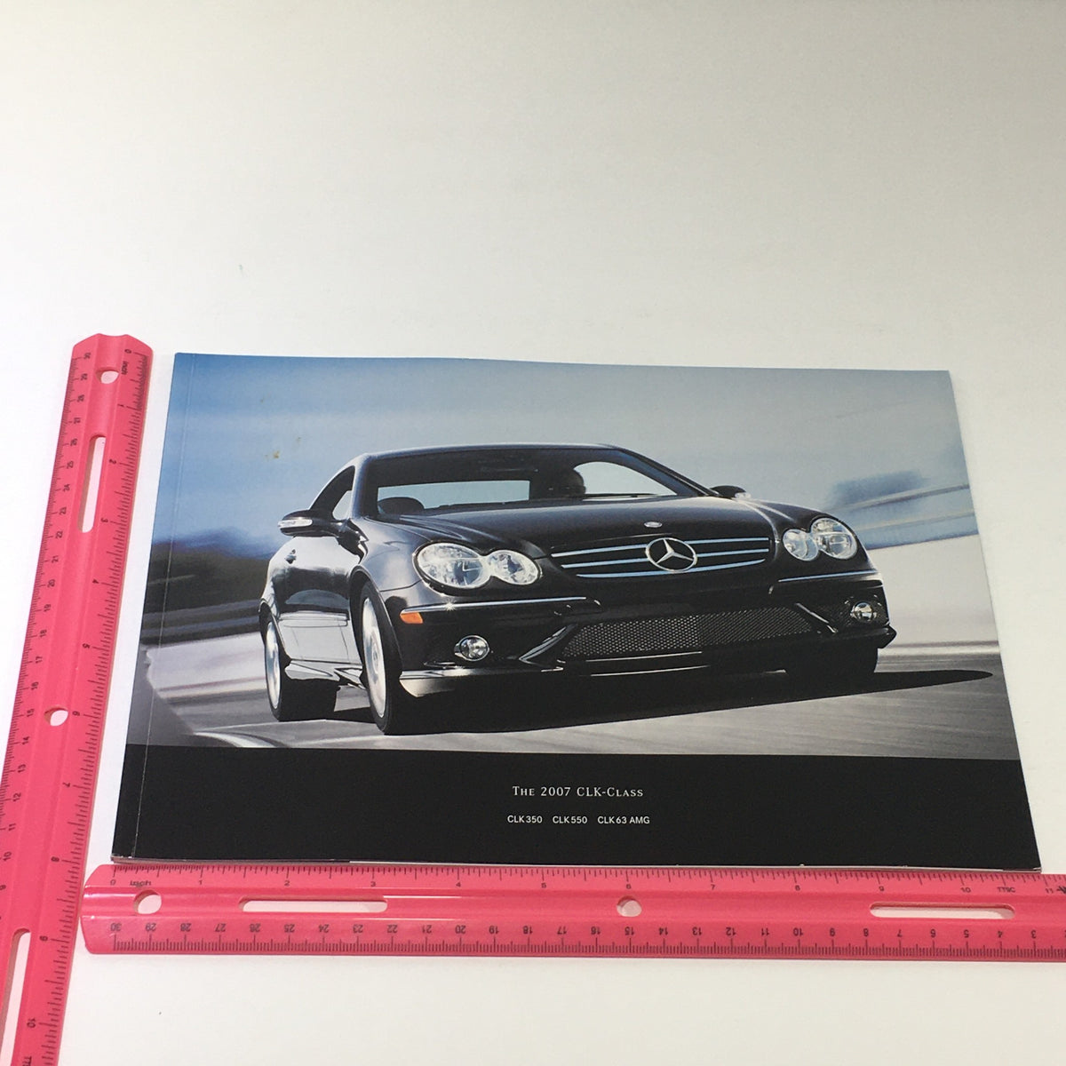 Image of the 2007 Mercedes-Benz CLK-Class showcasing the front view of the black sports car featured in the dealership brochure.