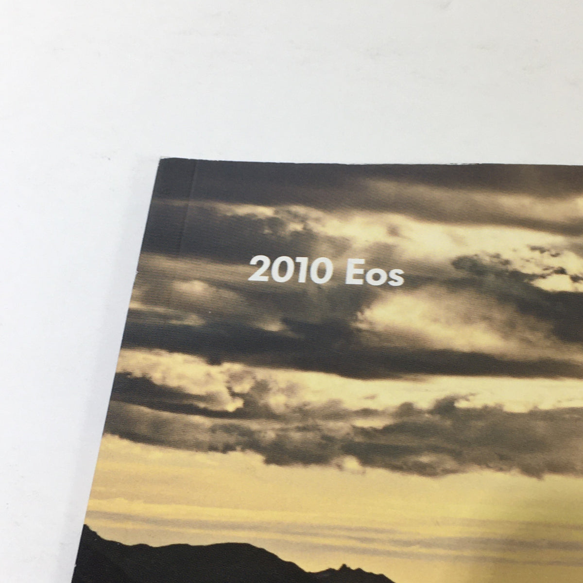 Close-up of the 2010 Volkswagen Eos title on the cover of the dealership brochure.