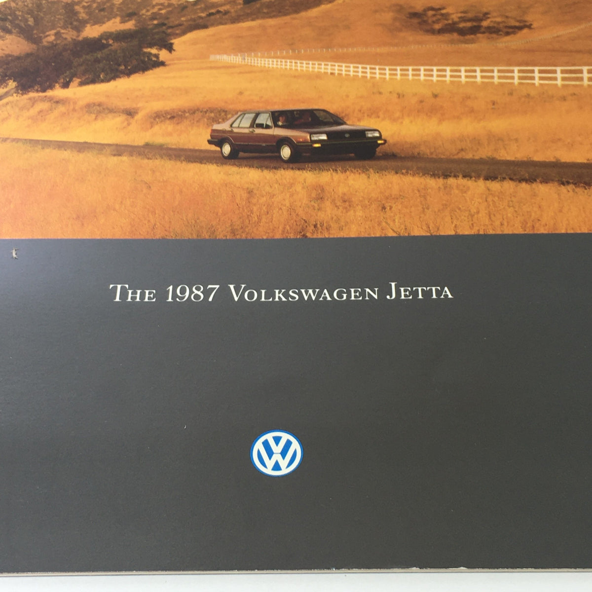 Close-up view of the cover of the 1987 Volkswagen Jetta Fox Golf GTI Dealership Car Auto Brochure Catalog, highlighting the title and Volkswagen logo.