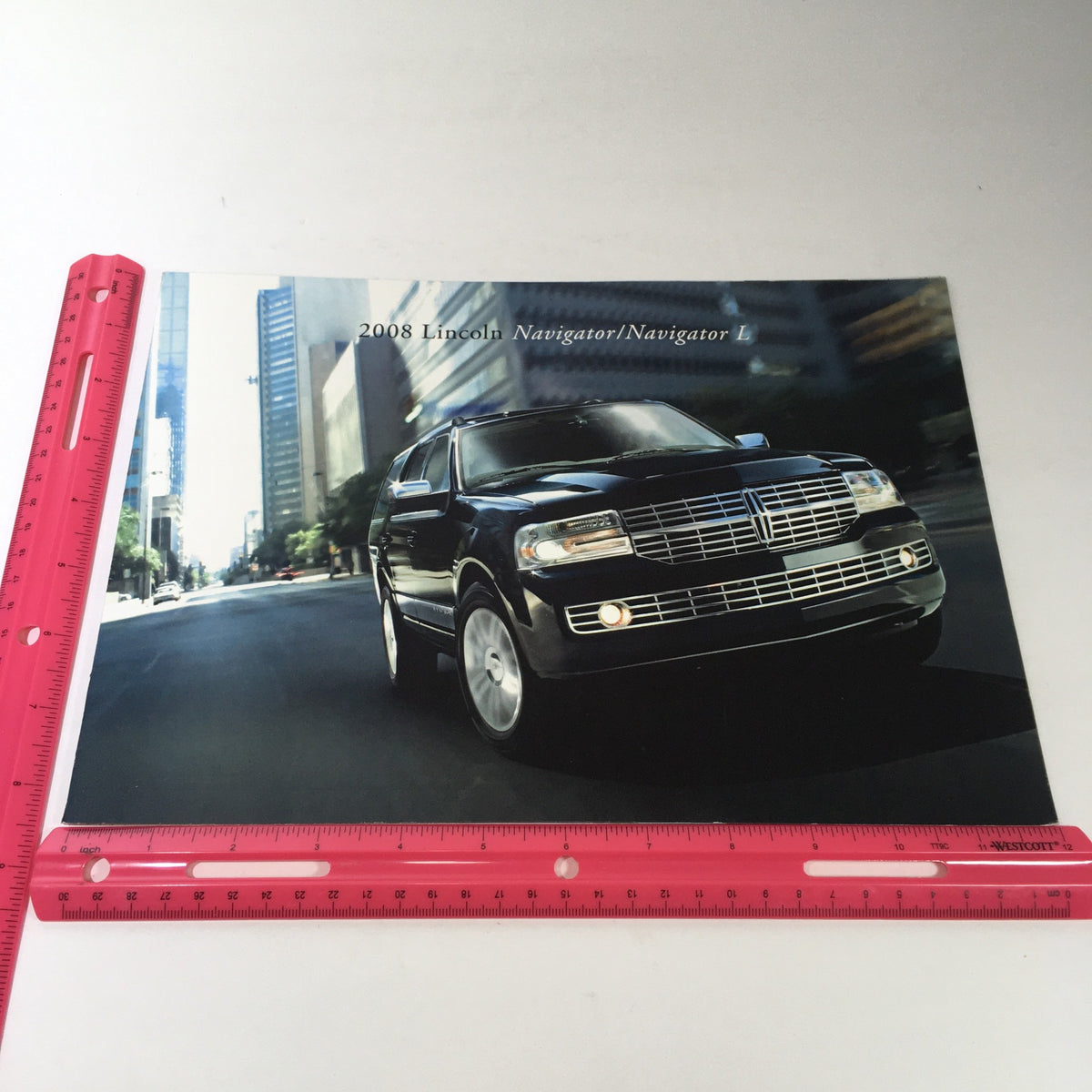 Detailed view of the 2008 Lincoln Navigator/Navigator L brochure with a ruler for size reference, showcasing the front view of the vehicle.
