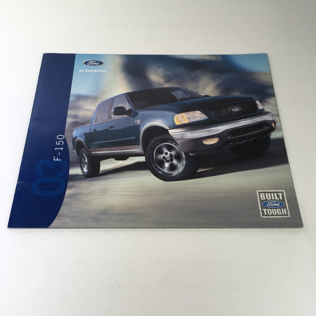 2003 Ford F-150 4x4 Pickup Dealership Car Auto Brochure Catalog cover showcasing a blue Ford F-150 pickup in an outdoor setting, emphasizing its rugged design and built tough features.