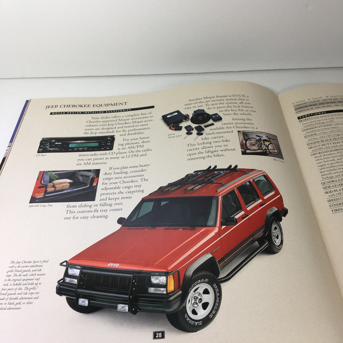 1995 The Jeep Book Dealership Car Auto Brochure Catalog featuring a Jeep Cherokee with highlighted equipment like a CD player and adjustable cargo tray, demonstrating car accessories.