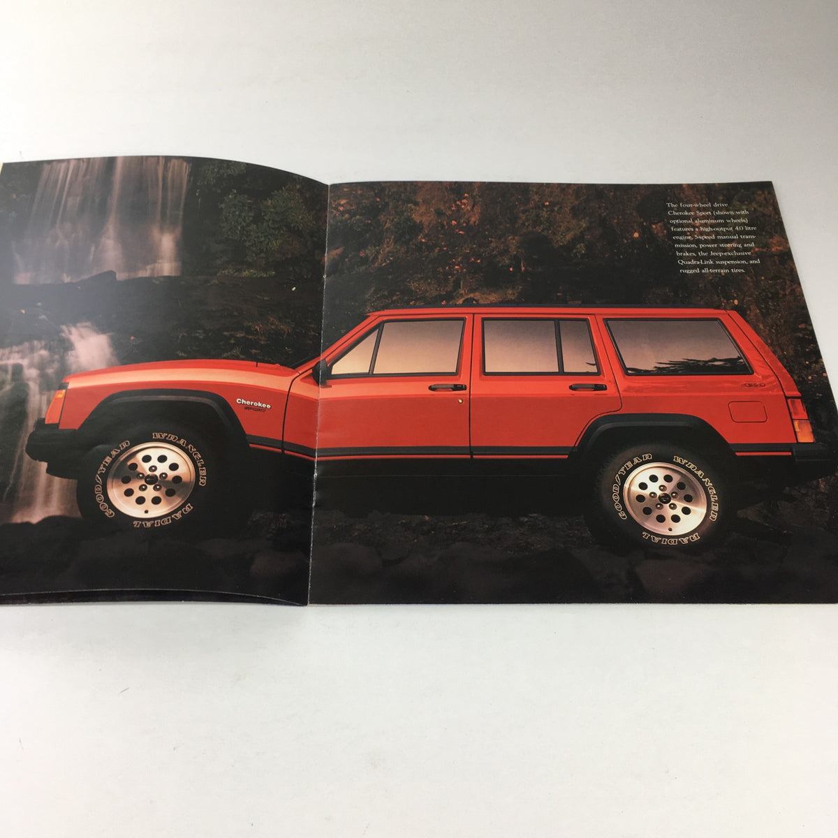 Interior spread of the 1996 Jeep TJ Wrangler and CJ-2A Dealership Car Auto Brochure Catalog showcasing the 1996 Jeep Cherokee in vibrant red.