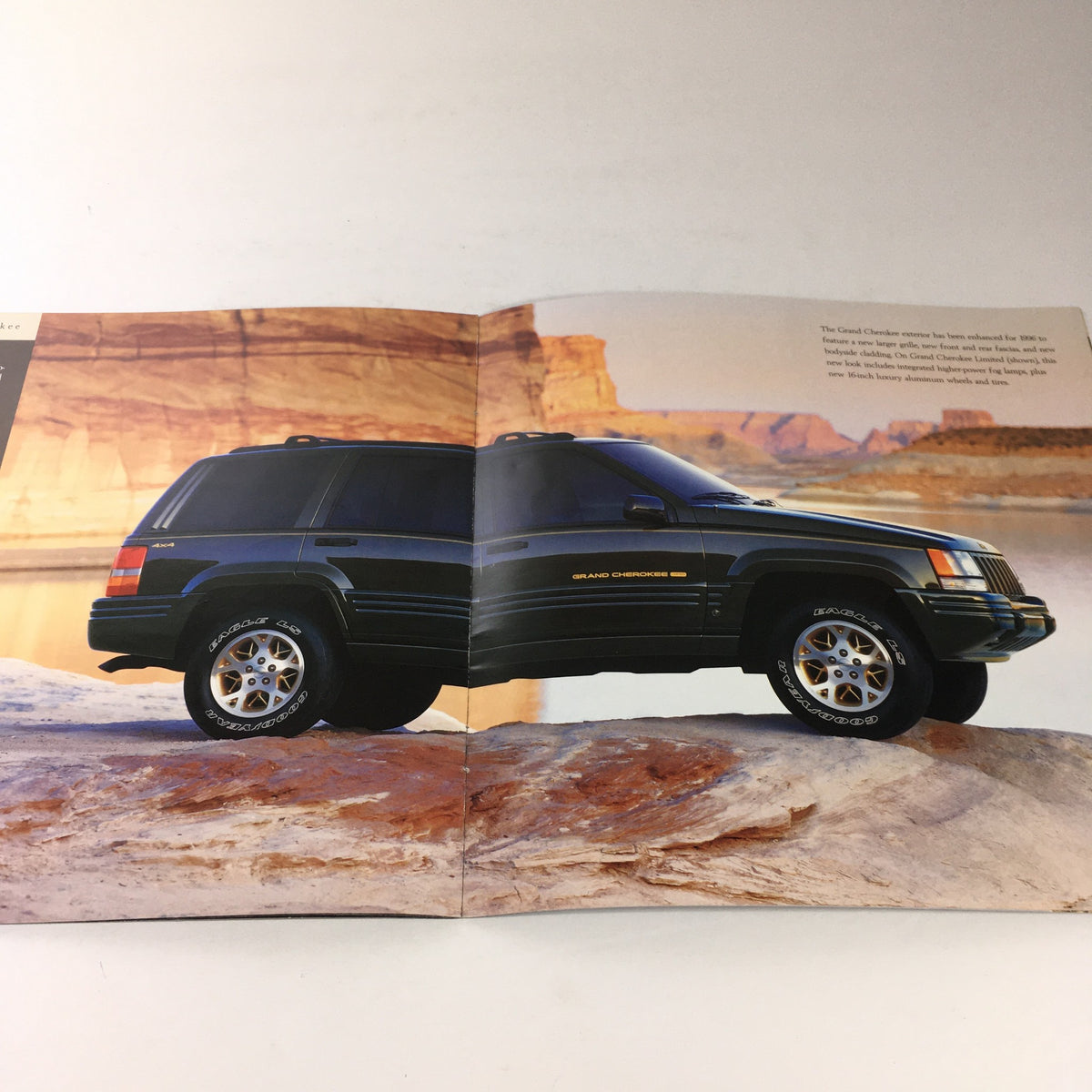 Another interior view from the 1996 Jeep TJ Wrangler and CJ-2A Dealership Car Auto Brochure Catalog displaying the 1996 Jeep Grand Cherokee in striking black.
