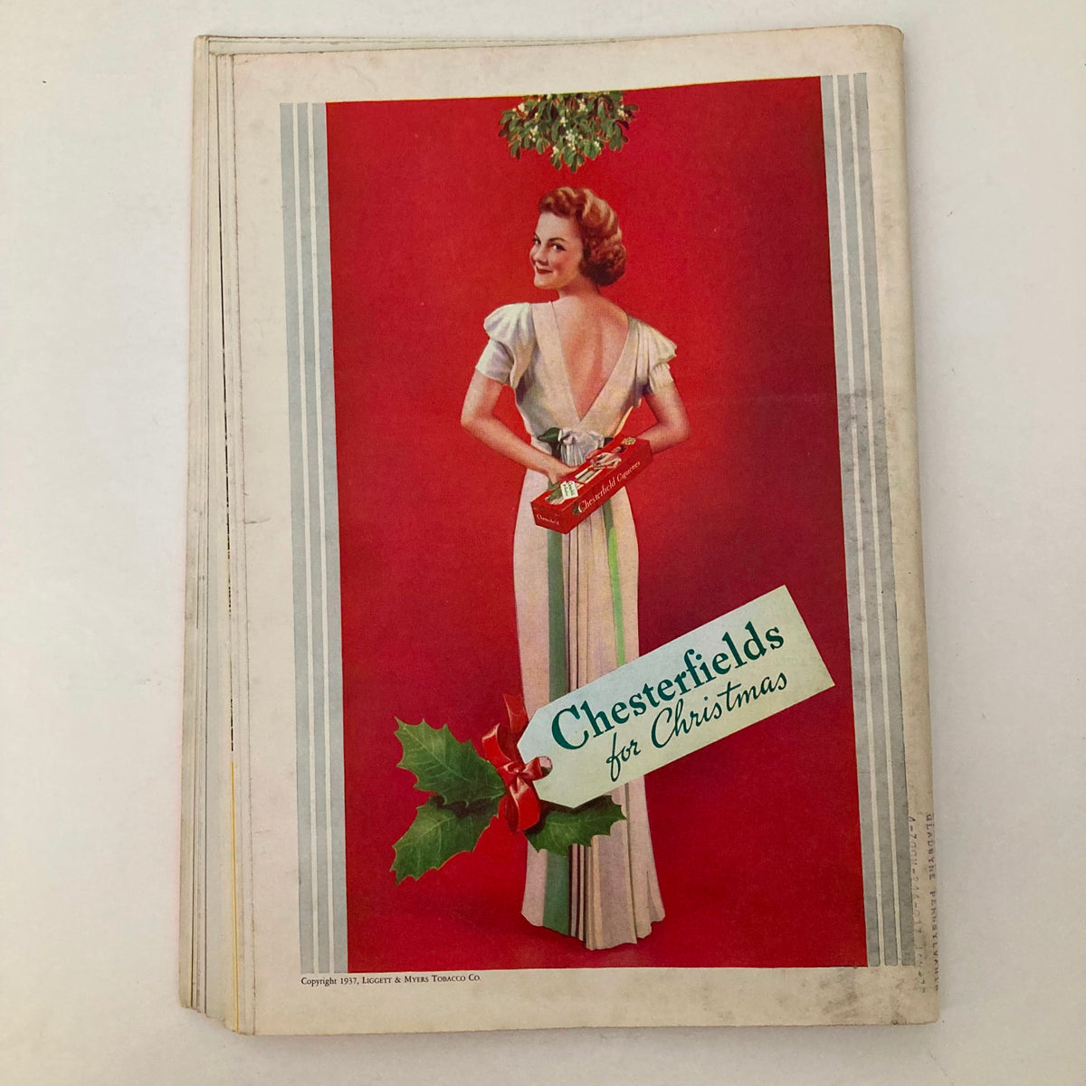 Vintage advertisement from VTG Time Magazine December 13 1937 Vol 30 No. 24 showcasing a woman in a dress promoting Chesterfield cigarettes for Christmas.