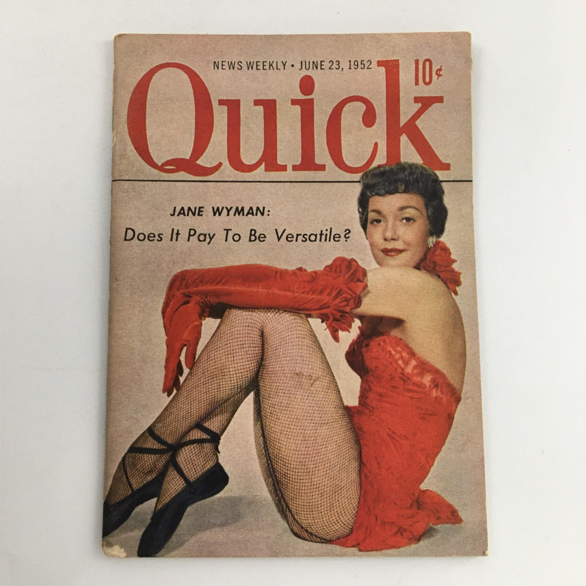 Vintage Quick Magazine cover from June 23, 1952, featuring actress Jane Wyman in a striking red outfit, posing in fishnet stockings with the title 'Does It Pay To Be Versatile?' prominently displayed.
