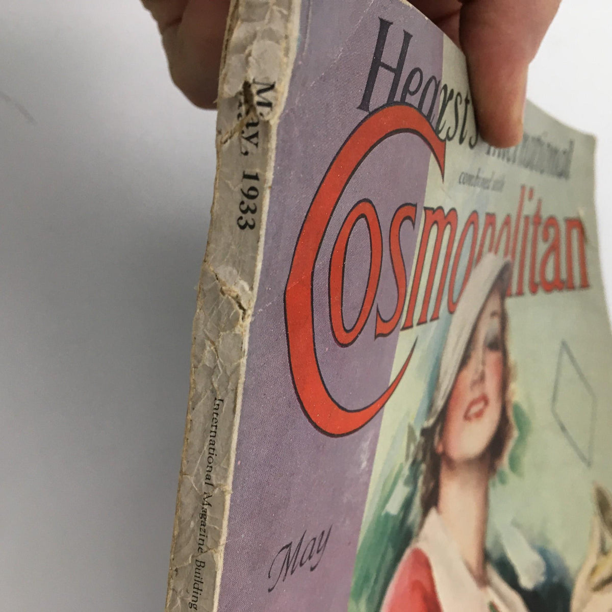 Side view of the May 1933 issue of Hearst's International with Cosmopolitan Magazine, displaying the magazine's title and date, along with visible wear on the cover.