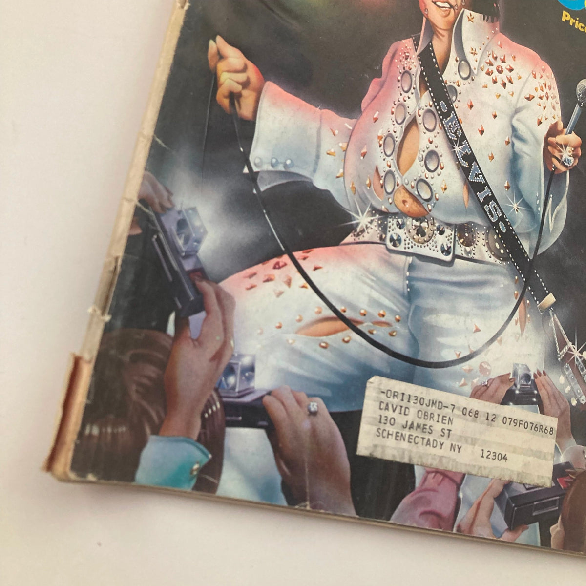 Close-up of the Cover of Vintage National Lampoon Magazine July 1976 showcasing an artistic portrayal of Elvis Presley, highlighting his glamorous outfit and the excitement of the audience.