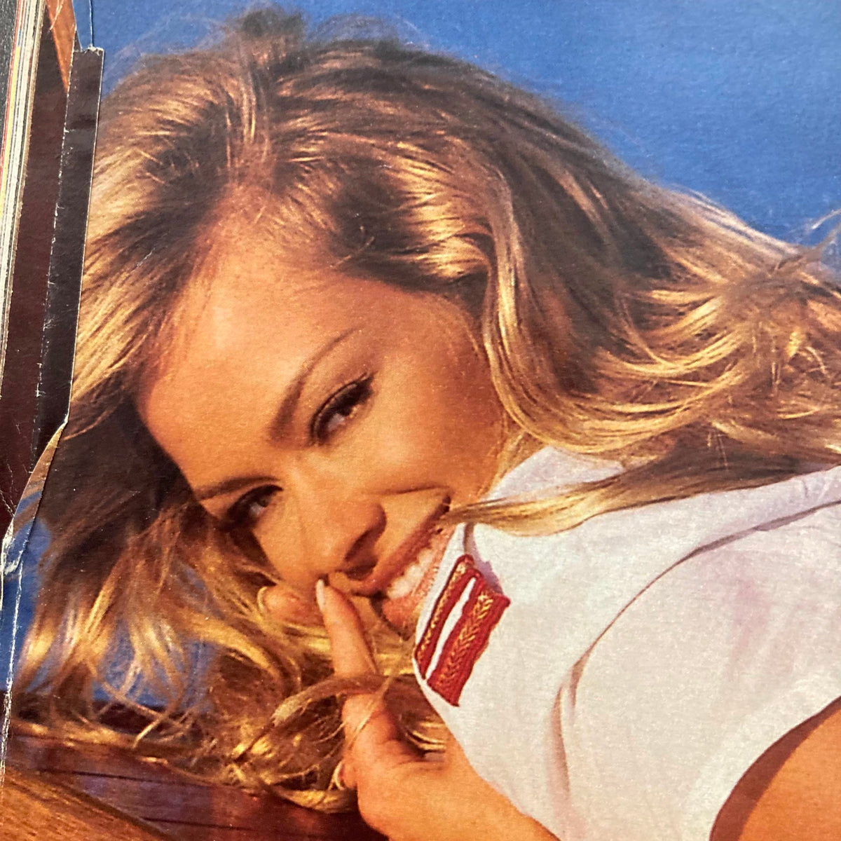 Inside page of Playboy Magazine April 1999 showing a smiling model with blonde hair, embodying the playful spirit of the era and showcasing fashion from the issue.
