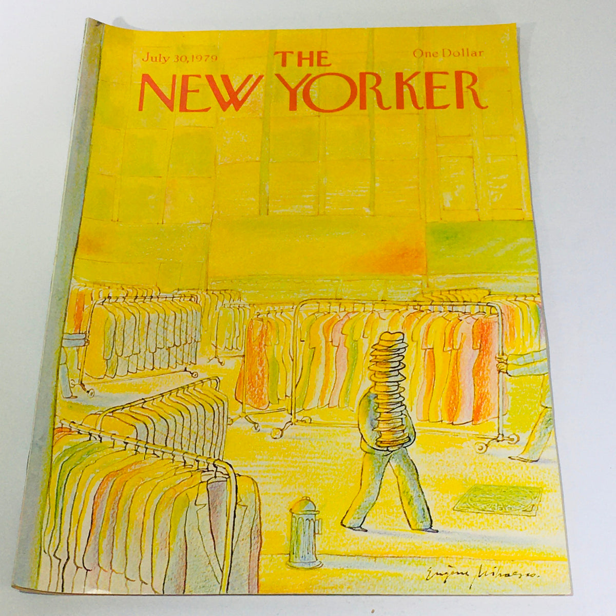 Cover of The New Yorker magazine from July 30, 1979, featuring a colorful illustration by Eugene Mihaesco, depicting a bustling scene with clothing racks and a person carrying stacks of items. Perfect for collectors of vintage publications.