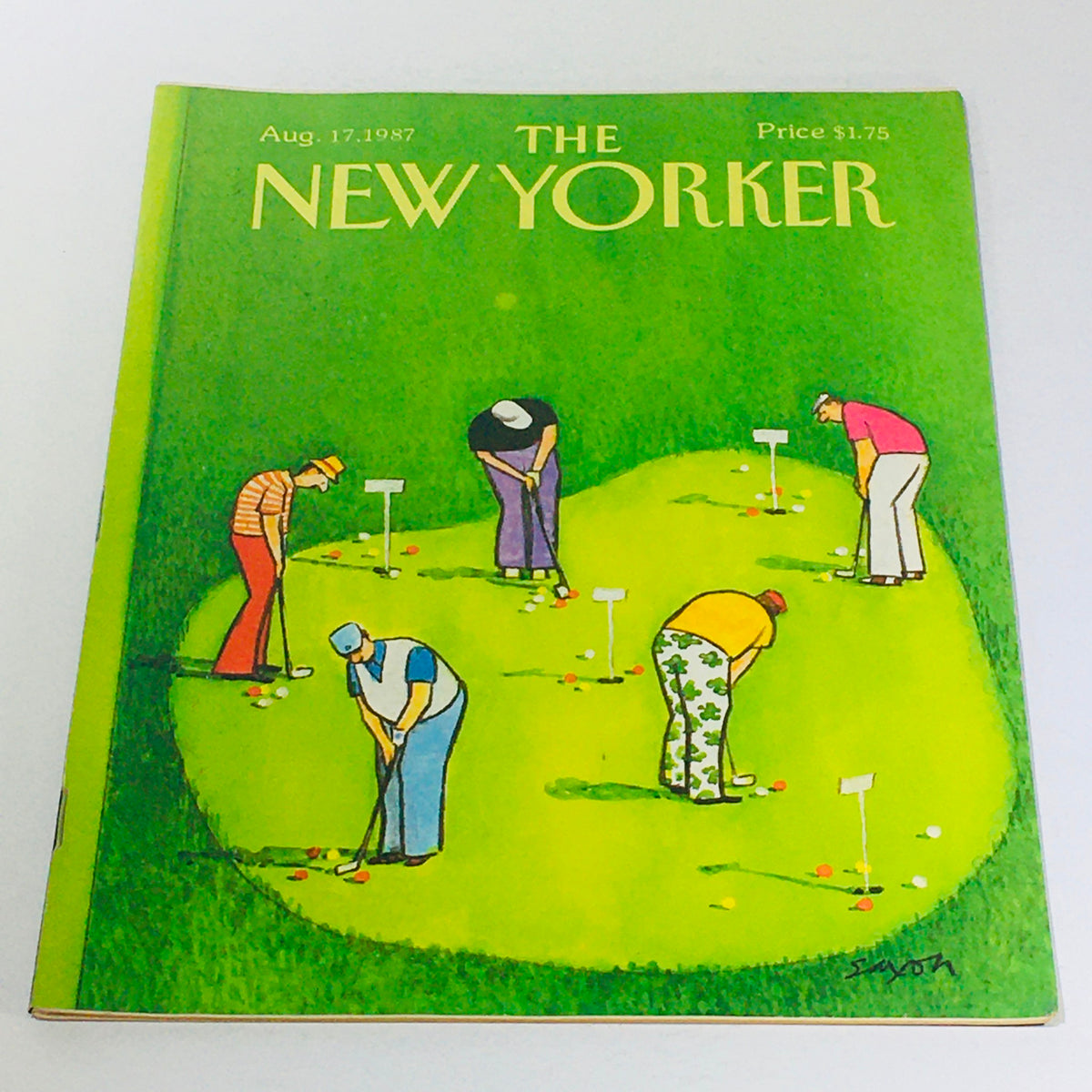 Cover of The New Yorker magazine from August 17, 1987, illustrated by Charles Saxon, featuring a vibrant green scene with golfers playing on a putting green.