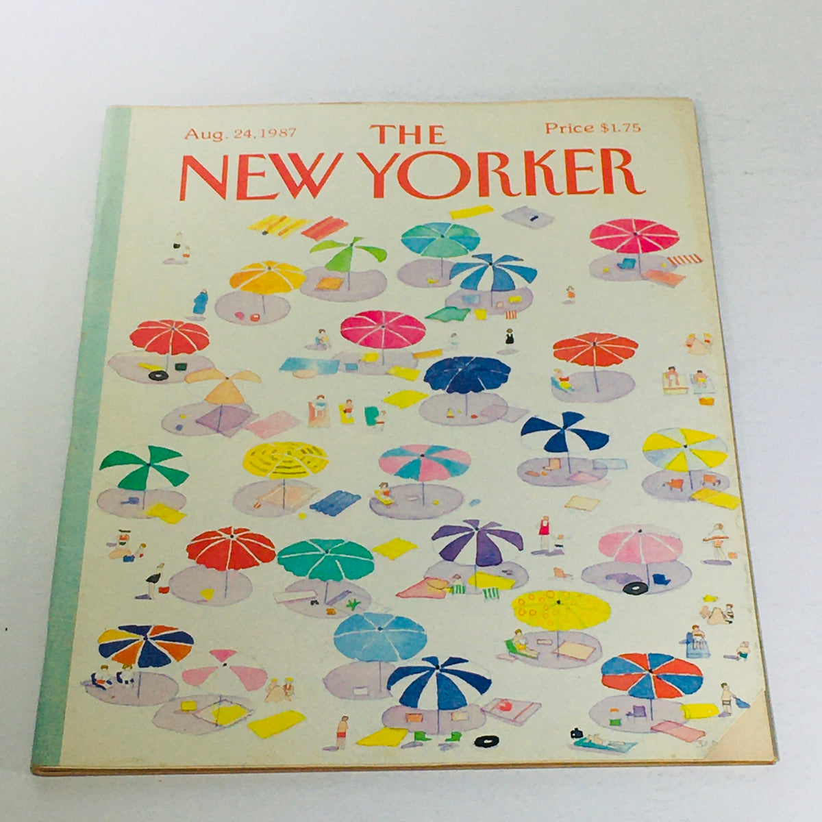 The New Yorker: August 24 1987 magazine cover featuring a colorful beach scene with umbrellas, beachgoers, and items scattered on the sand.