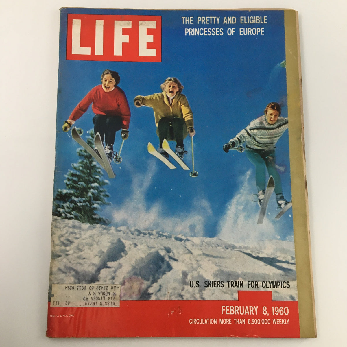 Cover of Life Magazine from February 8, 1960, featuring U.S. skiers training for the Olympics, depicting three young skiers in colorful attire jumping off a snowy slope.