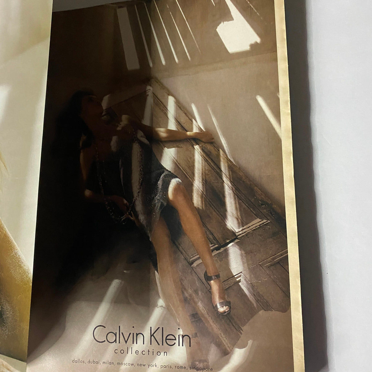Stylish advertisement showcasing a model in a Calvin Klein collection dress, featured in the August 2005 issue of W Magazine starring actress Katie Holmes on the cover.