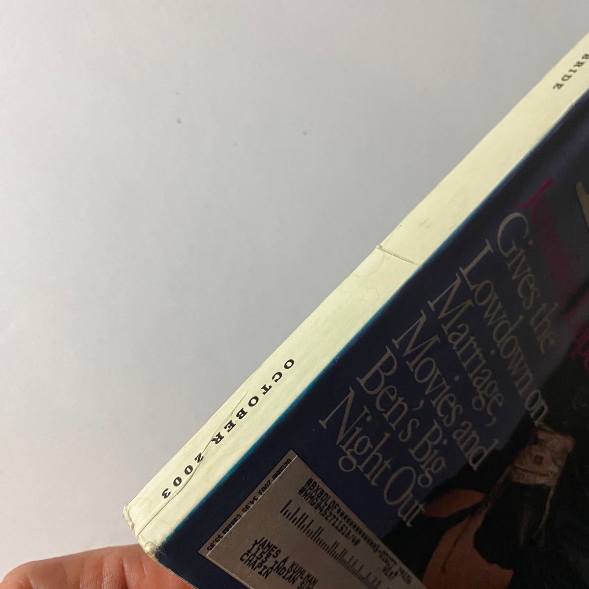 Edge view of W Magazine October 2003 showing the publication date at the spine, highlighting its vintage condition.