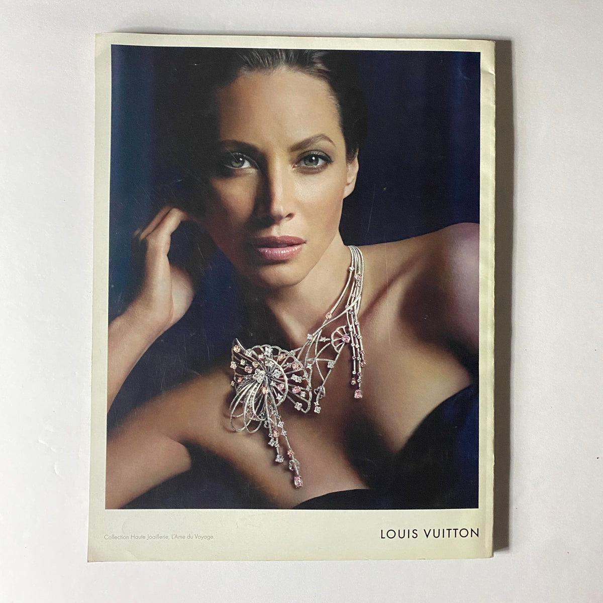 Louis Vuitton advertisement featuring a model adorned with exquisite jewelry, featured in W Magazine's November 2010 issue with Kim Kardashian on the cover.