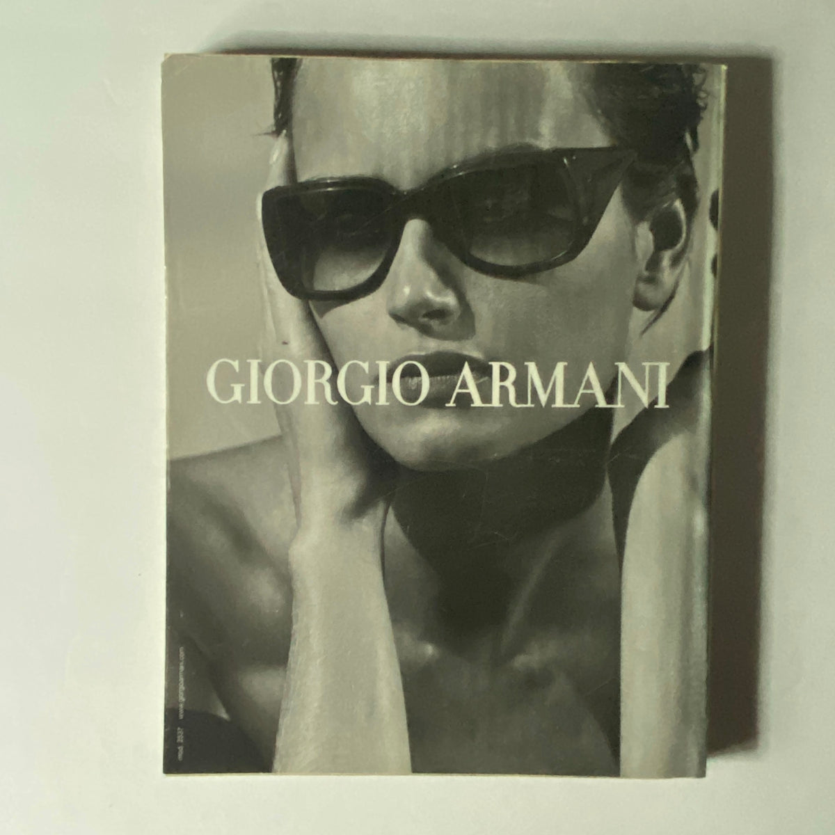 Giorgio Armani advertisement featured in W Magazine March 2002 with a monochromatic image of a model wearing stylish sunglasses.