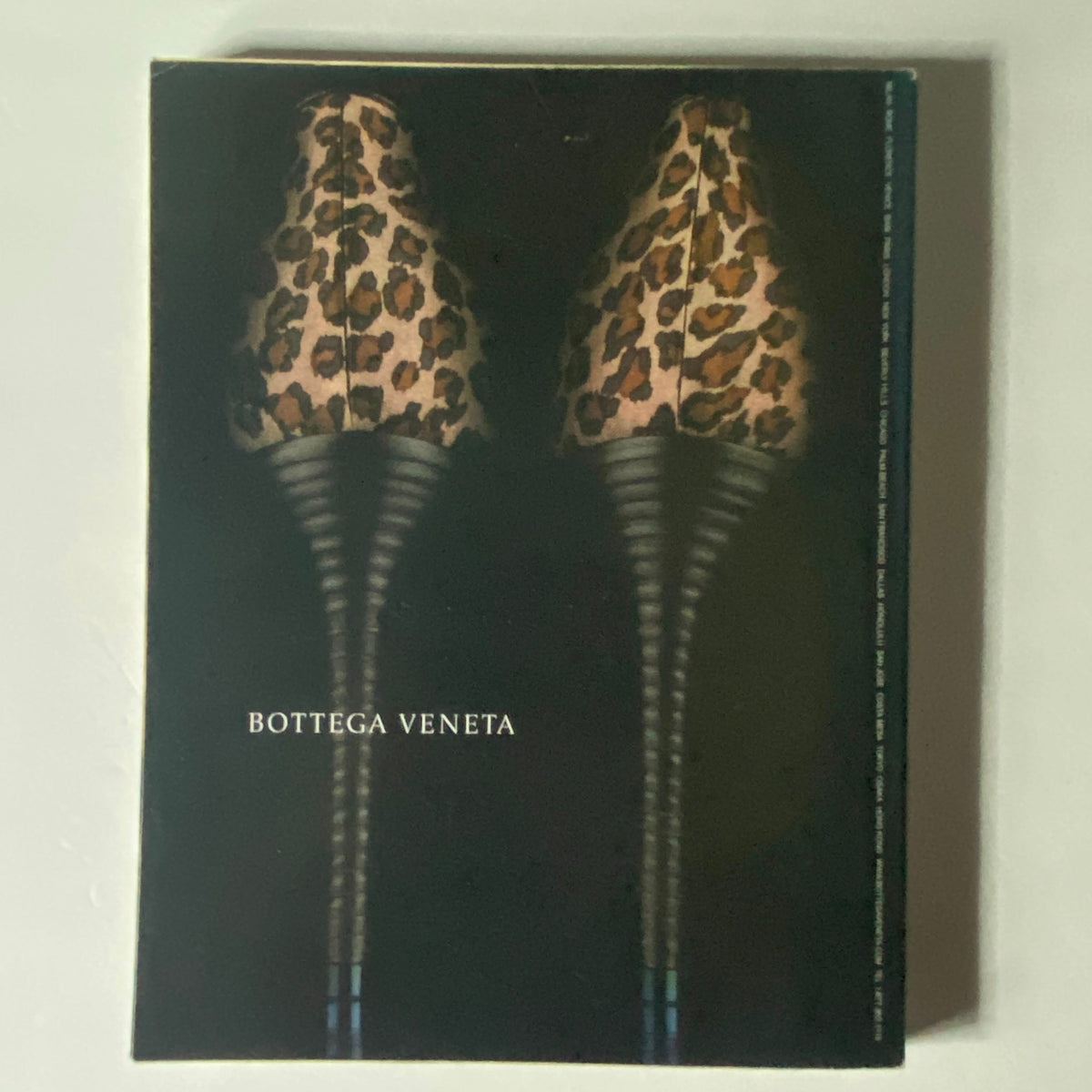 W Magazine October 2002 - An artistic advertisement showcasing stylish leopard print heels branded by Bottega Veneta, emphasizing luxury fashion and design trends from the early 2000s.
