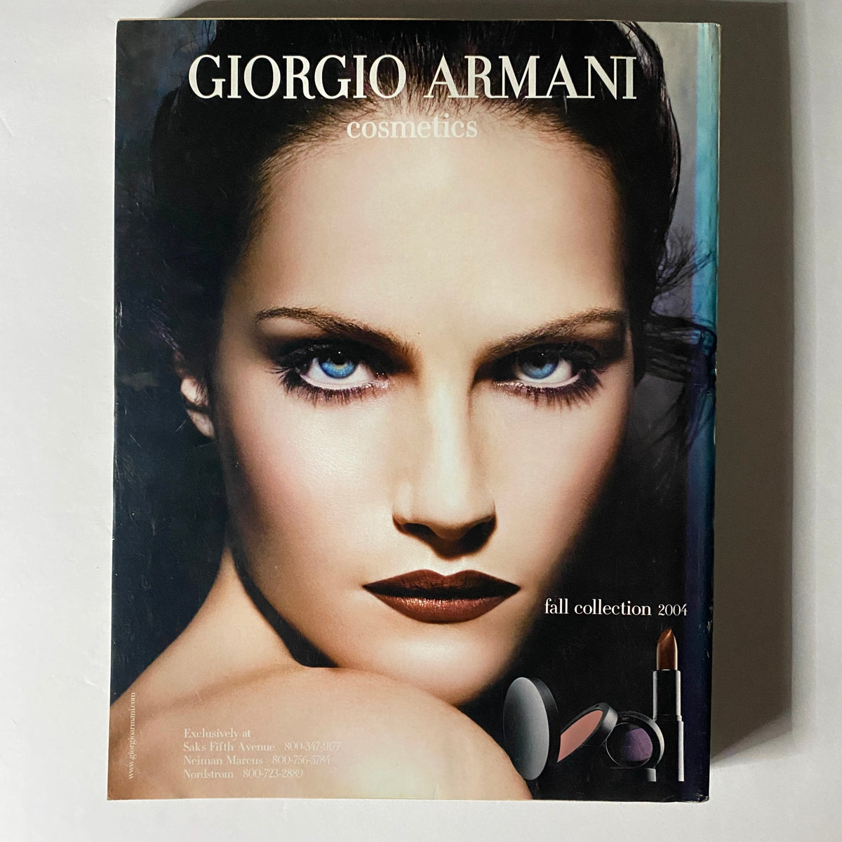 Giorgio Armani cosmetics advertisement highlighting the fall collection 2006 with a close-up image of a model's striking features, included in W Magazine September 2004.