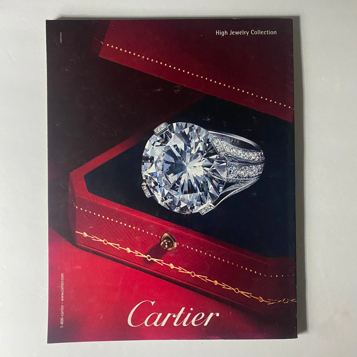 Cover of Cartier High Jewelry Collection showcasing a stunning diamond ring in an elegant red jewelry box, representing luxury and sophistication.