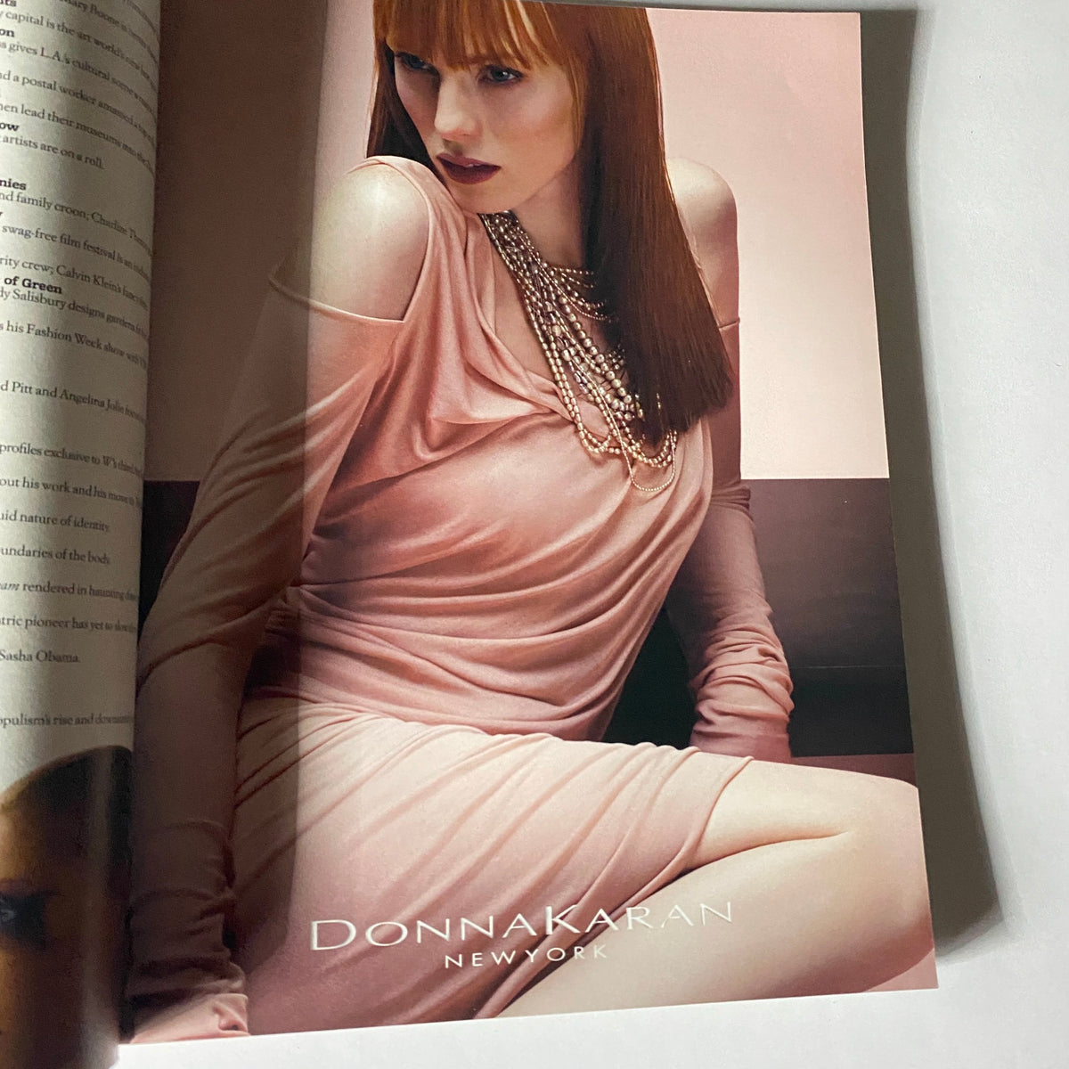 Fashion advertisement from W Magazine November 2008, featuring a model in a Donna Karan dress, capturing the essence of mid-2000s style.
