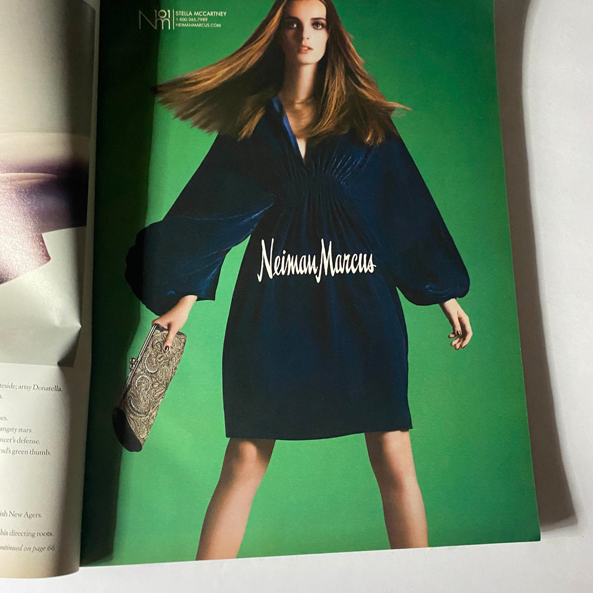 Stunning fashion advertisement from W Magazine October 2008 featuring a model in a flowing dark blue dress styled by Neiman Marcus, showcasing the elegance of late 2000s fashion.